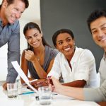 Group of jovial business professionals at a table